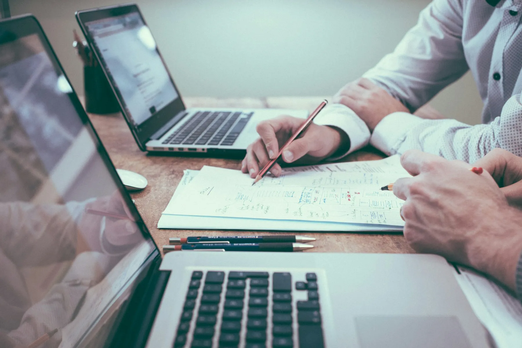 Colleagues reviewing business payment information at a desk
